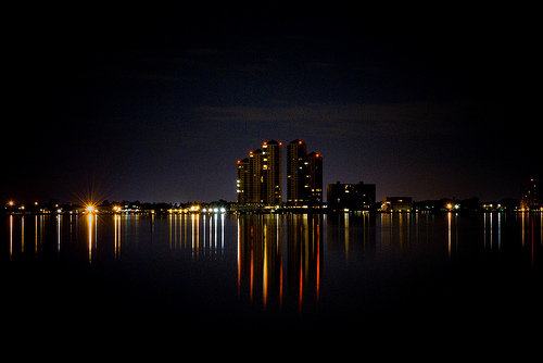 Fort Myers riverfront skyline at night with illuminated towers reflected in the Caloosahatchee River